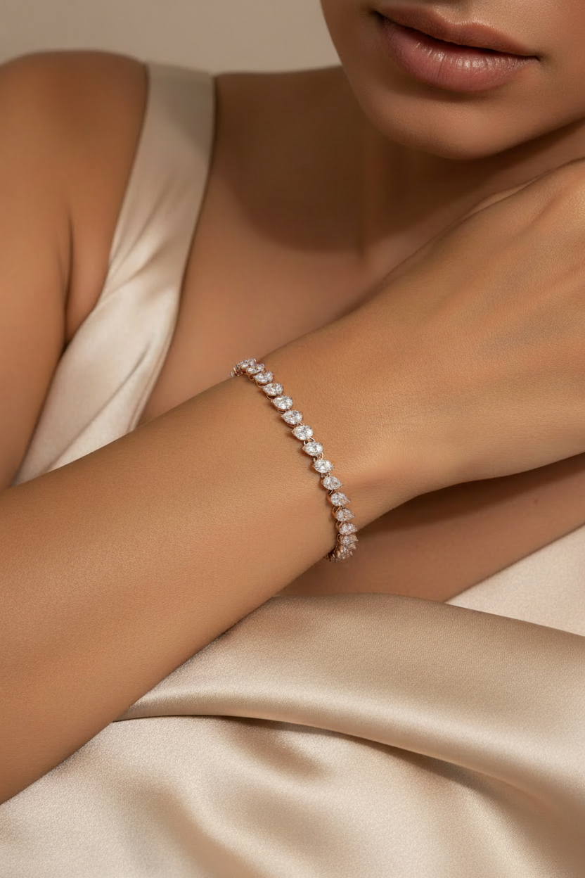 Close-up of a diamond bracelet on a person's wrist with a neutral background