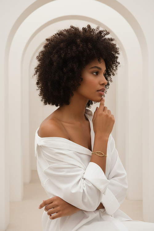 Aura Knot Bracelet — Gold delicate bracelet champagne gold-tone with knot detail lifestyle shot worn on model against neutral background, ZARIÉ fine jewellery SÉRÉNITÉ collection