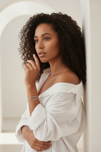 Aura Knot Bracelet — Silver delicate bracelet silver-tone with knot detail lifestyle shot worn on model against neutral background, ZARIÉ fine jewellery ÉLORA collection