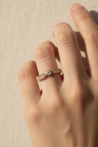Bezel Arc Ring open band ring lifestyle shot worn on model against neutral background, ZARIÉ fine jewellery LUMIÈRE collection