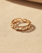 Bezel Glow Ring open band ring lifestyle shot worn on model against neutral background, ZARIÉ fine jewellery LUMIÈRE collection