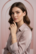 Bird Charm Bracelet- Silver delicate bracelet silver-tone lifestyle shot worn on model against neutral background, ZARIÉ fine jewellery ÉLORA collection