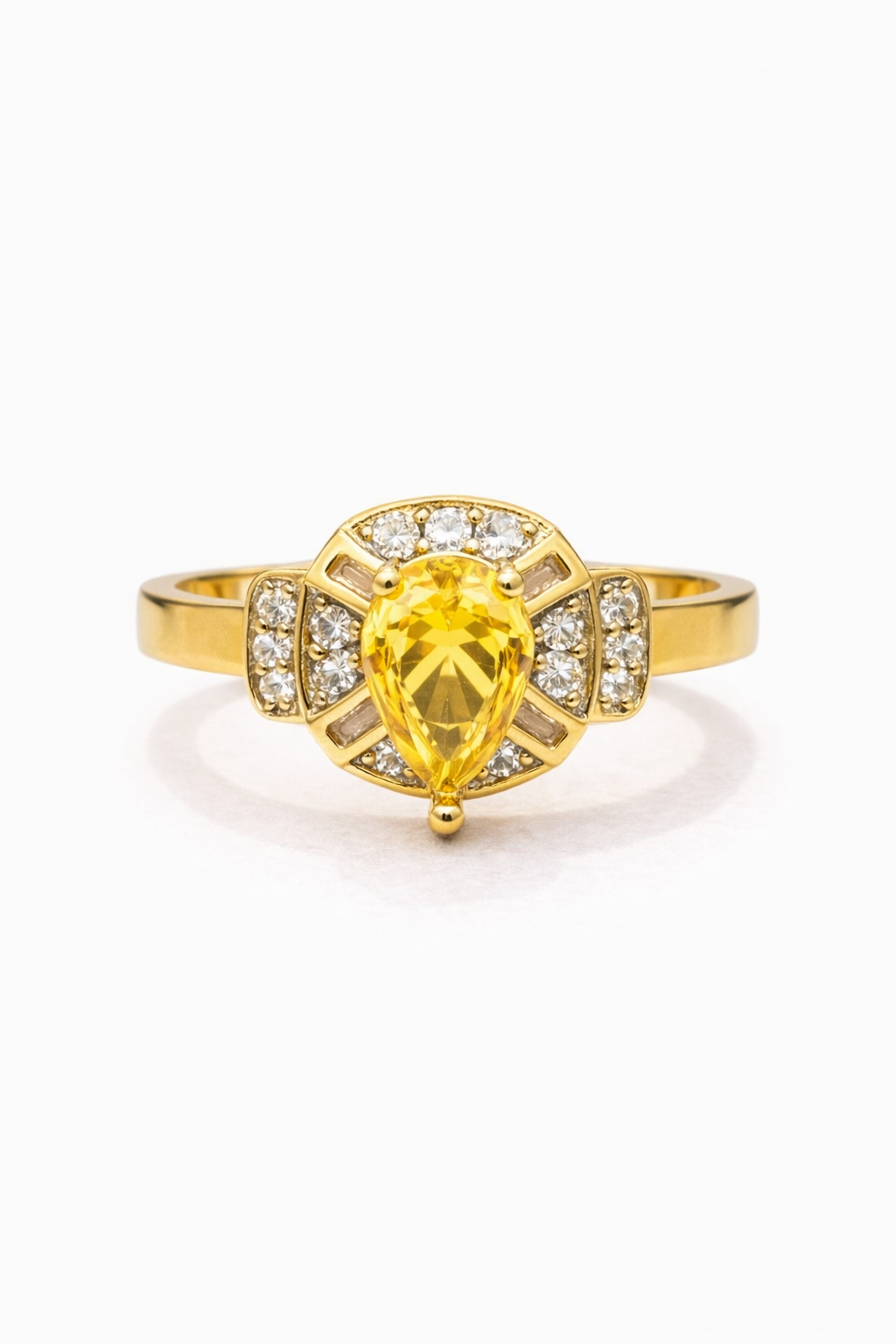 Gold ring with a yellow gemstone and diamond accents on a white background