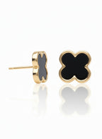 Gold earrings with black heart-shaped stones on a white background