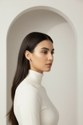 Clover Stud Earrings – Red stud earrings four-leaf clover motif lifestyle shot worn on model against neutral background, ZARIÉ fine jewellery RAYONNE collection