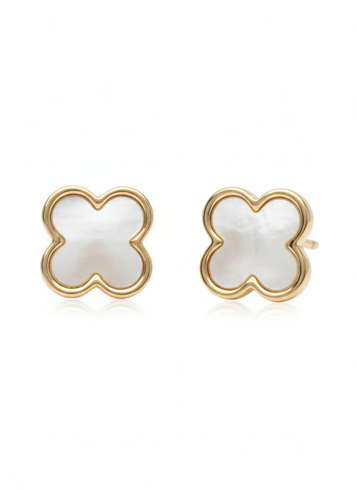 Pair of champagne gold four-leaf clover stud earrings with white mother-of-pearl inlay centres photographed on soft white background, showing polished metallic finish, symmetrical clover design with four rounded petals, and delicate refined craftsmanship