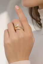 Coiled Radiance Ring open band ring lifestyle shot worn on model against neutral background, ZARIÉ fine jewellery LUMIÈRE collection