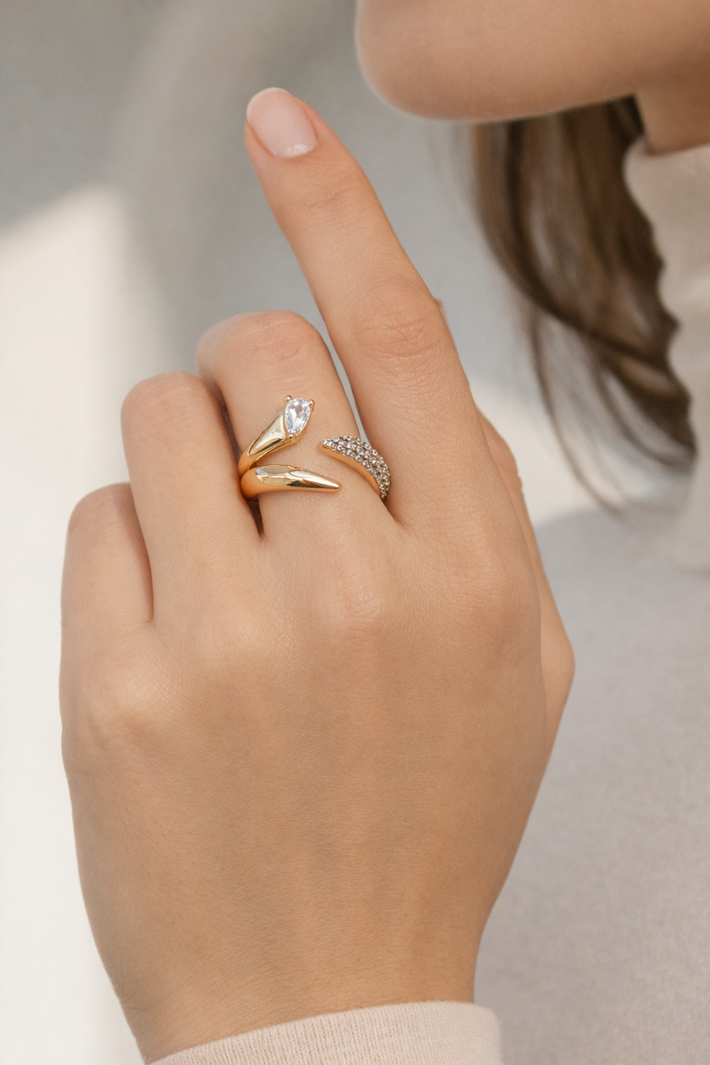 Coiled Radiance Ring open band ring lifestyle shot worn on model against neutral background, ZARIÉ fine jewellery LUMIÈRE collection