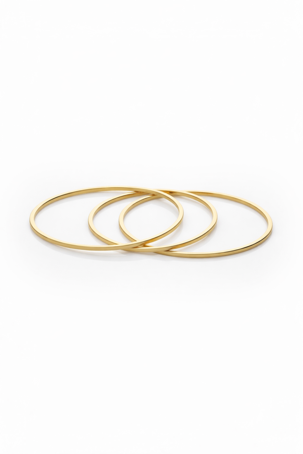 Contour Trio Bangles — Gold fine jewellery piece champagne gold-tone on clean white background, product flat lay, ZARIÉ fine jewellery SÉRÉNITÉ collection