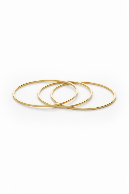 Contour Trio Bangles — Gold fine jewellery piece champagne gold-tone on clean white background, product flat lay, ZARIÉ fine jewellery SÉRÉNITÉ collection