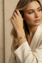 Contour Trio Bangles — Gold fine jewellery piece champagne gold-tone lifestyle shot worn on model against neutral background, ZARIÉ fine jewellery SÉRÉNITÉ collection
