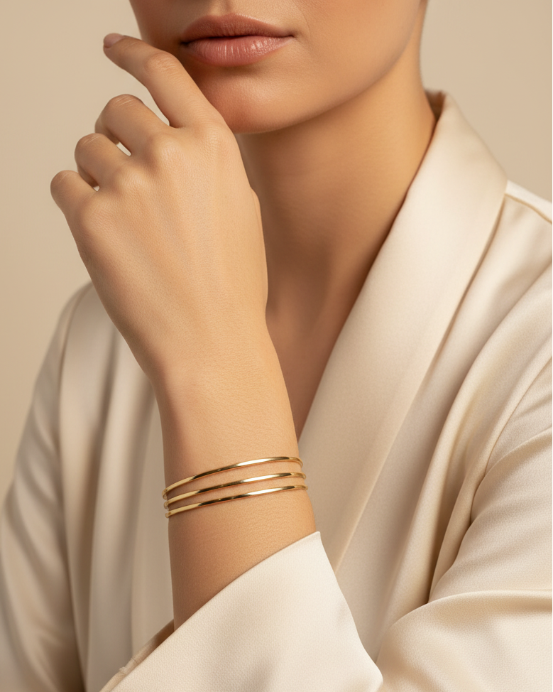 Contour Trio Bangles — Gold fine jewellery piece champagne gold-tone lifestyle shot worn on model against neutral background, ZARIÉ fine jewellery SÉRÉNITÉ collection