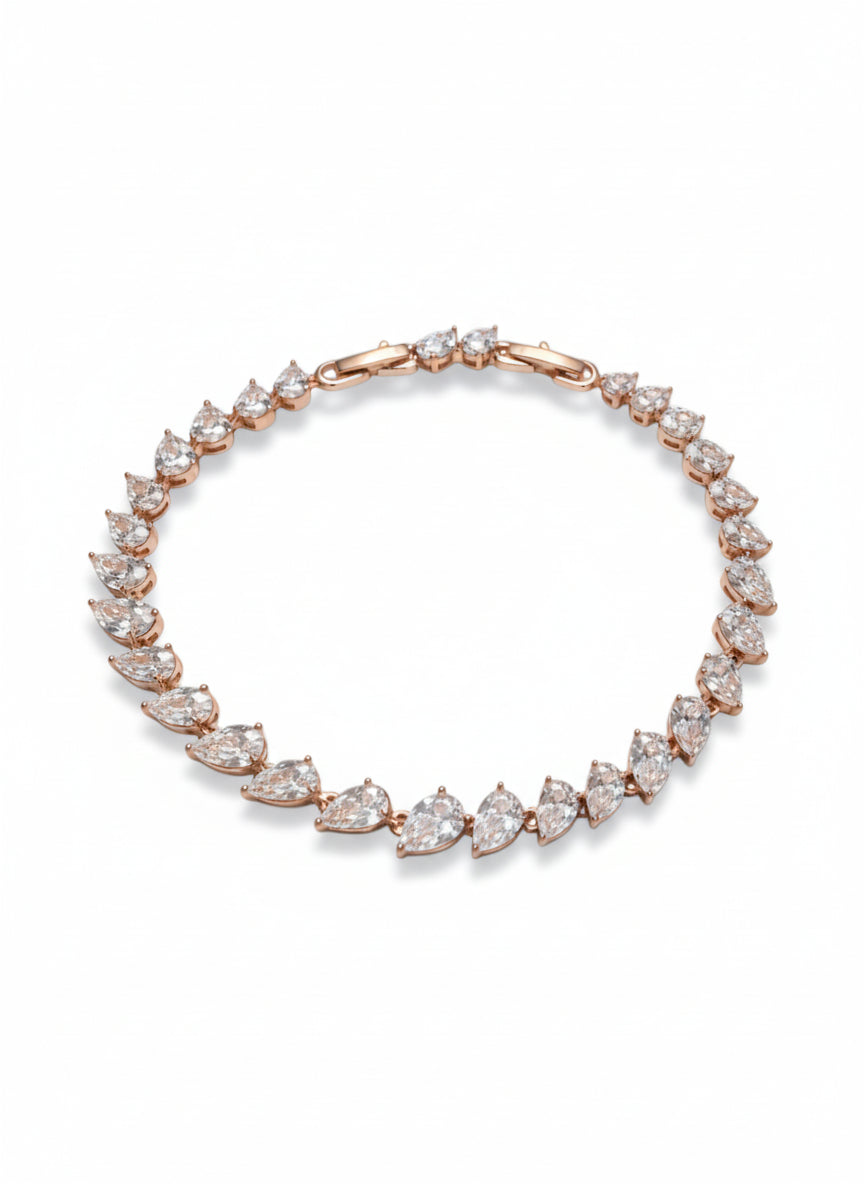Crossed Teardrop Line Bracelet drop earrings on clean white background, product flat lay, ZARIÉ fine jewellery LUMIÈRE collection