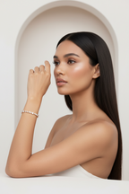 Crossed Teardrop Line Bracelet drop earrings lifestyle shot worn on model against neutral background, ZARIÉ fine jewellery LUMIÈRE collection