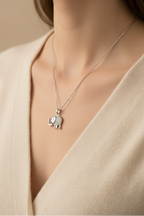 Elephant Crest Necklace — Silver fine chain necklace silver-tone lifestyle shot worn on model against neutral background, ZARIÉ fine jewellery ÉLORA collection