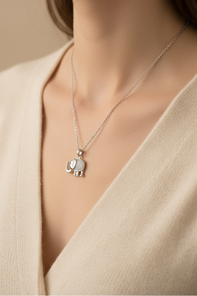 Elephant Crest Necklace — Silver fine chain necklace silver-tone lifestyle shot worn on model against neutral background, ZARIÉ fine jewellery ÉLORA collection