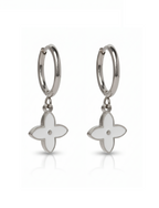 Silver earrings with white flower-shaped charms on a white background