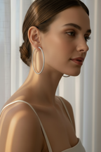 Full Pavé Hoop Earrings — Silver hoop earrings silver-tone with pavé stone setting lifestyle shot worn on model against neutral background, ZARIÉ fine jewellery ÉLORA collection