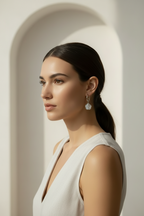 Half-Inlay Clover Hoop Earrings – Silver hoop earrings silver-tone four-leaf clover motif lifestyle shot worn on model against neutral background, ZARIÉ fine jewellery ÉLORA collection