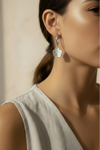 Half-Inlay Clover Hoop Earrings – Silver hoop earrings silver-tone four-leaf clover motif lifestyle shot worn on model against neutral background, ZARIÉ fine jewellery ÉLORA collection