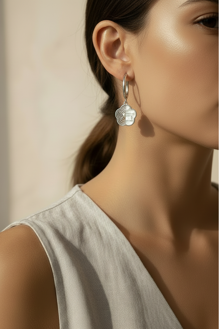 Half-Inlay Clover Hoop Earrings – Silver hoop earrings silver-tone four-leaf clover motif lifestyle shot worn on model against neutral background, ZARIÉ fine jewellery ÉLORA collection
