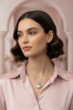 Heart Crest Necklace — Silver fine chain necklace silver-tone lifestyle shot worn on model against neutral background, ZARIÉ fine jewellery AMOURÉ collection