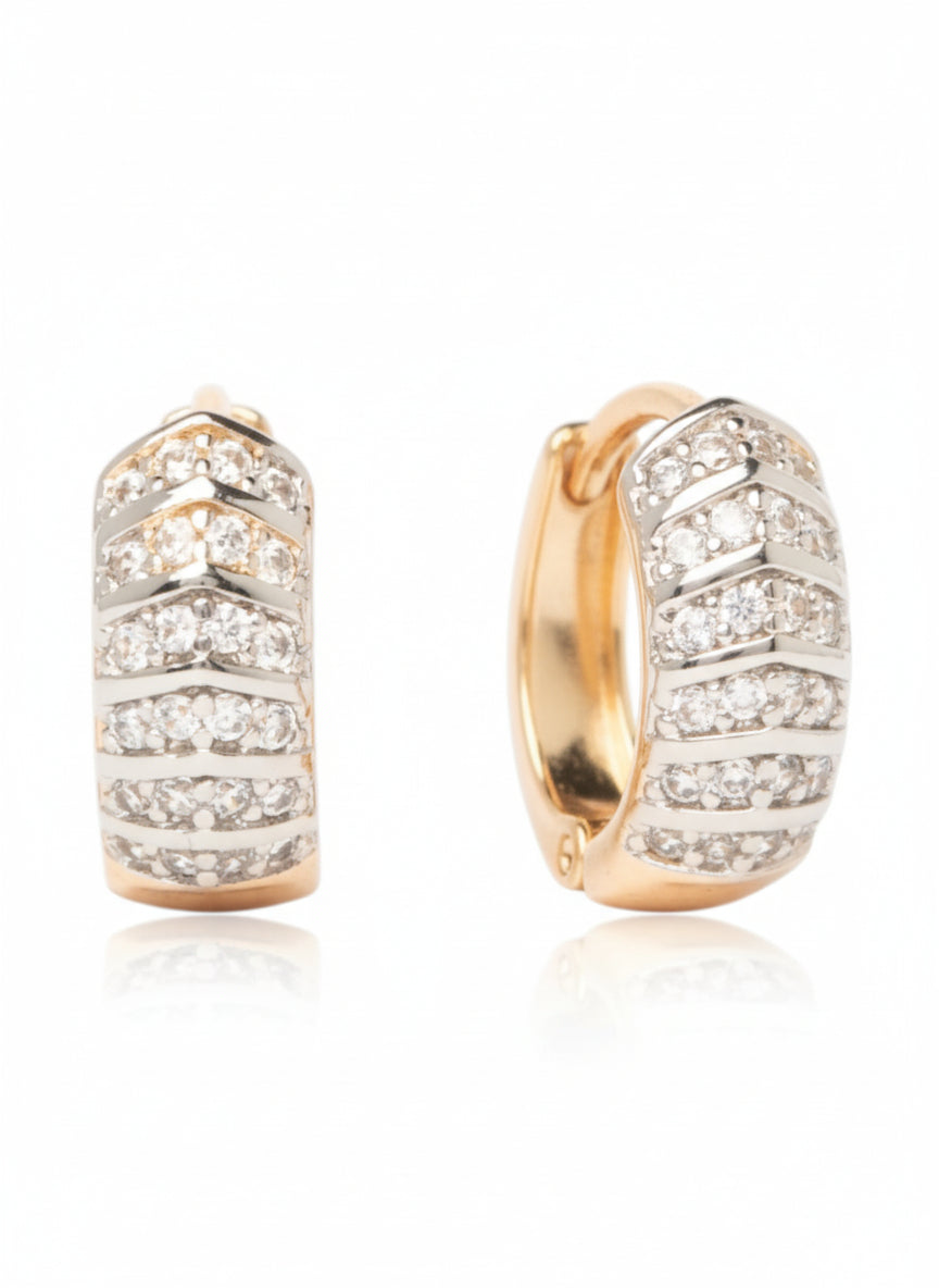 Pair of gold hoop earrings with diamond accents on a white background