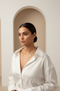 Migratory Line Necklace — Silver fine chain necklace silver-tone lifestyle shot worn on model against neutral background, ZARIÉ fine jewellery ÉLORA collection