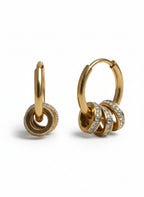 Gold hoop earrings with interlocking rings and small diamonds on a white background