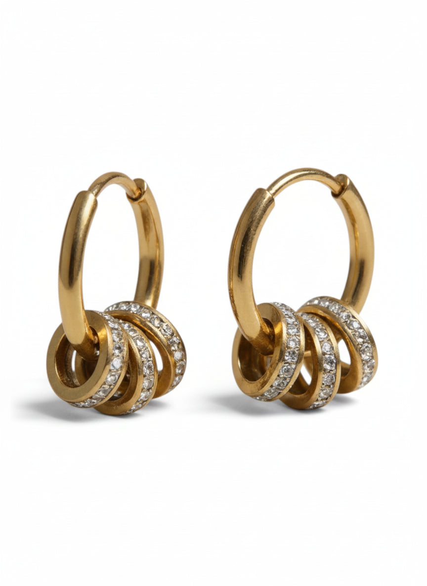Gold hoop earrings with diamond accents on a white background