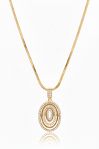 Orbit Halo Pendant Necklace — Gold pendant necklace champagne gold-tone lifestyle shot worn on model against neutral background, ZARIÉ fine jewellery LUMIÈRE collection