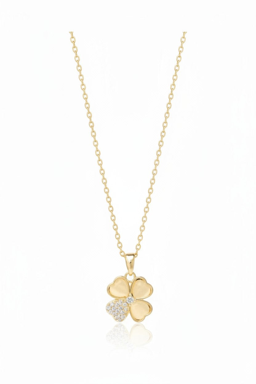 Petite Clover Necklace — Gold fine chain necklace champagne gold-tone four-leaf clover motif on clean white background, product flat lay, ZARIÉ fine jewellery HARMONIE collection