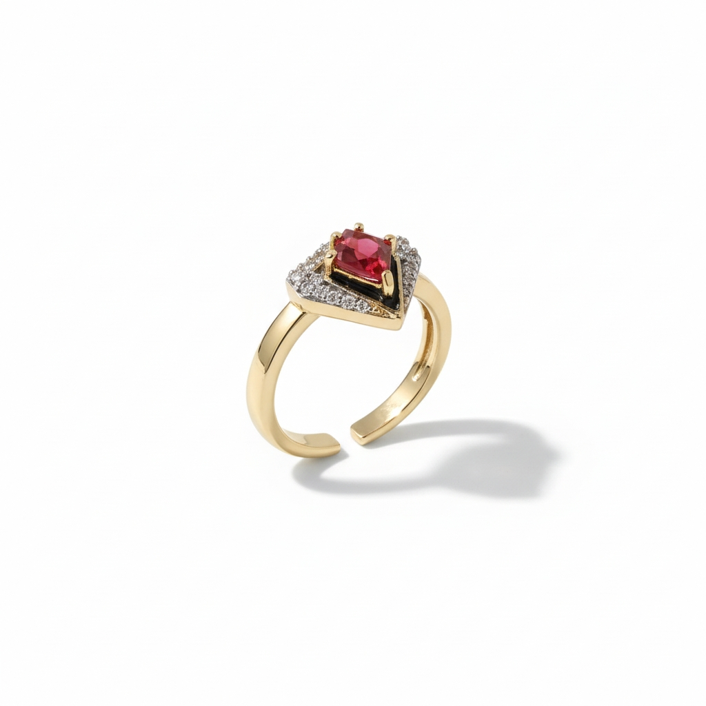 Detail view of red stone halo ring in champagne gold with deep red centre stone and pavé crystal surround against cream background, refined minimal craftsmanship showing intricate halo setting and polished finish