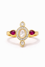 Gold ring with red gemstones and clear stones on a white background