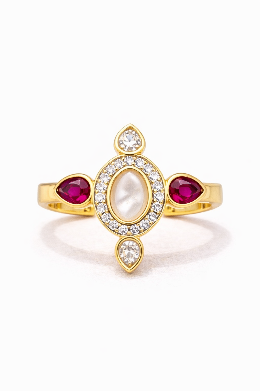 Gold ring with red gemstones and clear stones on a white background