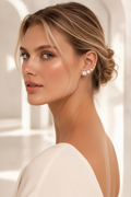 Woman wearing elegant earrings with a neutral background