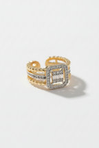 Detail view of square halo open ring in champagne gold featuring pavé crystal-set square frame on adjustable band against cream background, refined minimal craftsmanship with polished metallic finish and elegant design