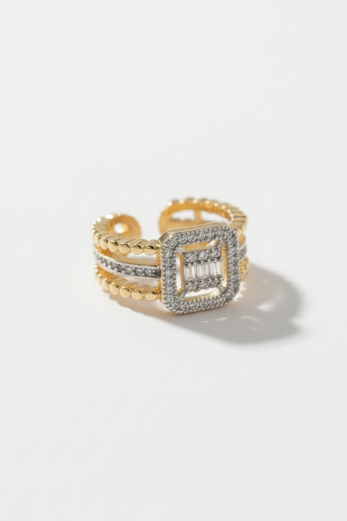 Detail view of square halo open ring in champagne gold featuring pavé crystal-set square frame on adjustable band against cream background, refined minimal craftsmanship with polished metallic finish and elegant design