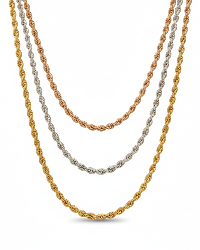 Three twisted chain necklaces in rose gold, silver and champagne gold tones laid flat on soft beige linen background, showing varying chain lengths and polished metallic finishes, ultra-thin minimal design with refined craftsmanship and warm beige aesthetic
