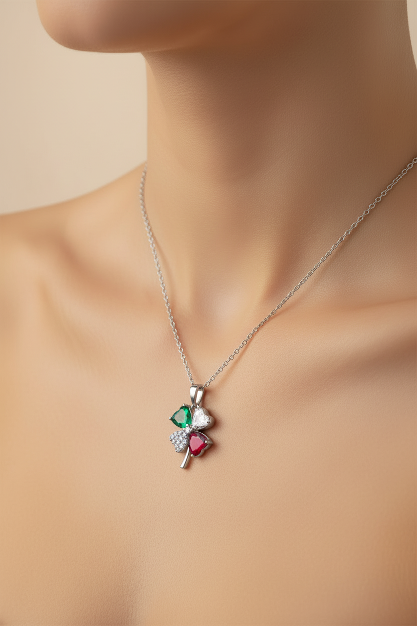 Verdant Clover Necklace — Silver fine chain necklace silver-tone four-leaf clover motif close-up detail shot showing craftsmanship on soft beige background, ZARIÉ fine jewellery RAYONNE collection