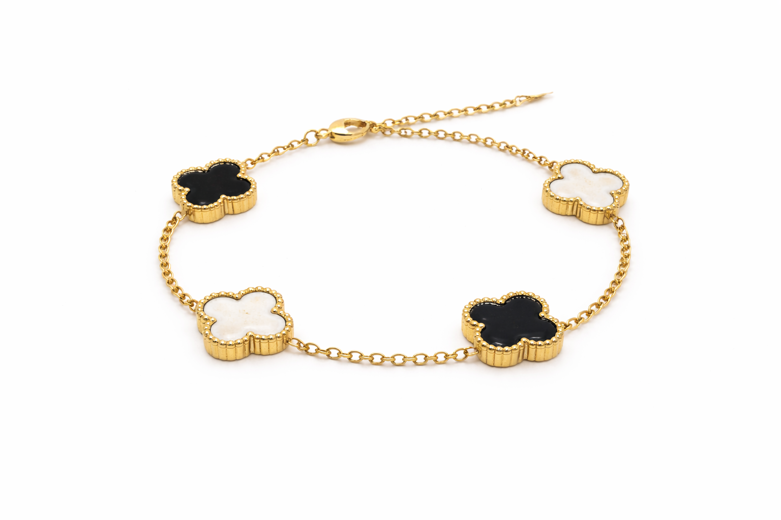 Gold bracelet with clover-shaped charms on a white background