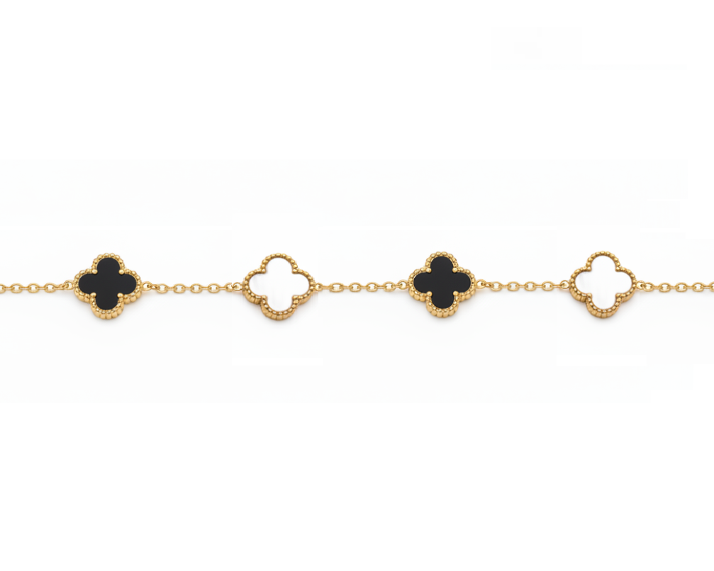 Gold bracelet with black clover-shaped charms on a white background