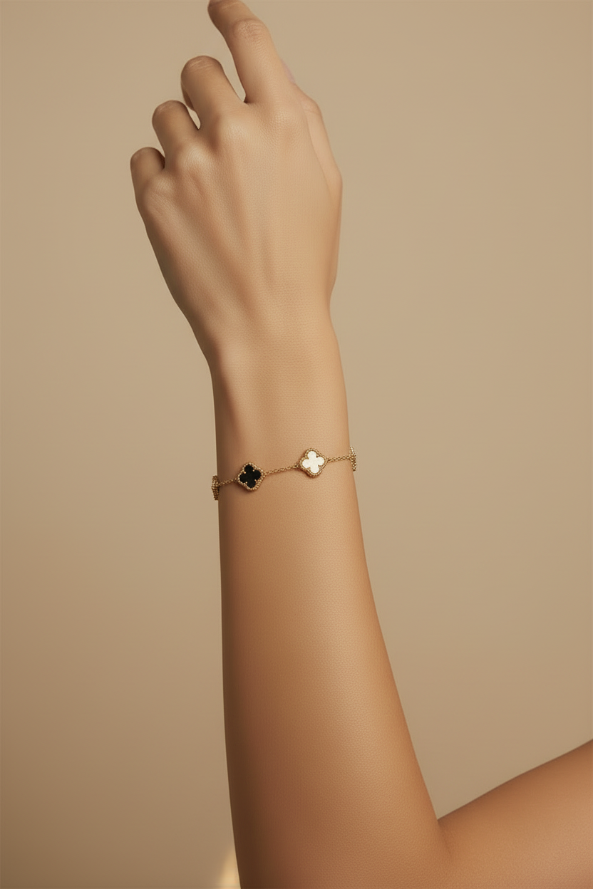 Hand wearing a delicate bracelet on a beige background