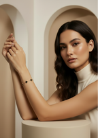 Verre Clover Bracelet — Black on Gold delicate bracelet champagne gold-tone four-leaf clover motif lifestyle shot worn on model against neutral background, ZARIÉ fine jewellery SÉRÉNITÉ collection