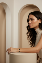 Verre Clover Bracelet — Black on Gold delicate bracelet champagne gold-tone four-leaf clover motif lifestyle shot worn on model against neutral background, ZARIÉ fine jewellery SÉRÉNITÉ collection