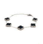 Silver bracelet with black clover-shaped charms on a white background