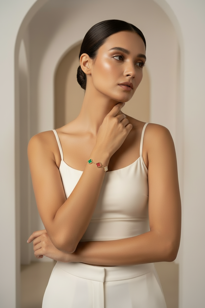 Woman wearing a white top and colorful bracelet in a neutral setting
