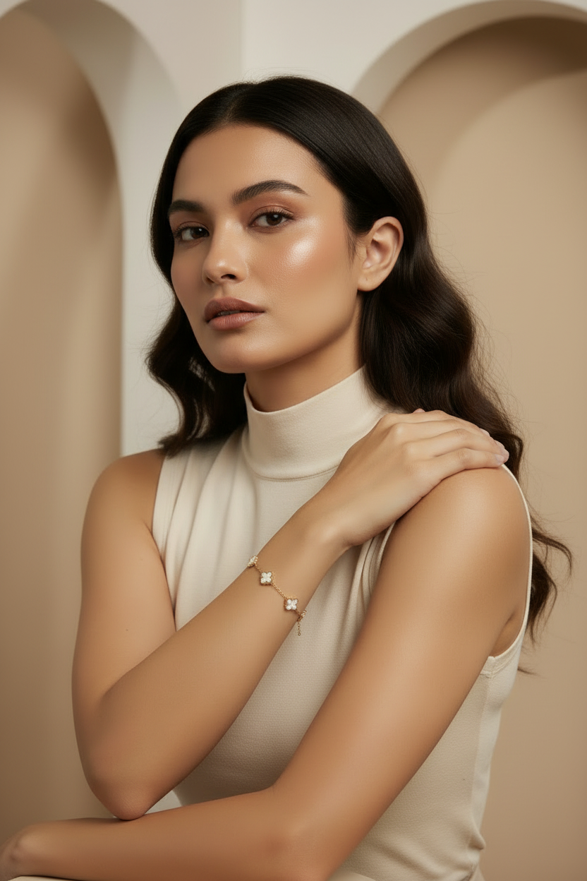 Woman in a white sleeveless top standing against a beige wall with arches.