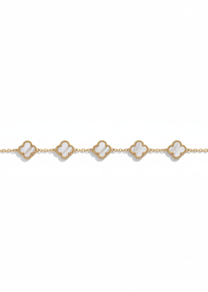 Gold bracelet with heart-shaped charms on a white background