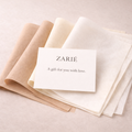 Zarié gift card with beige and white paper on a light pink background